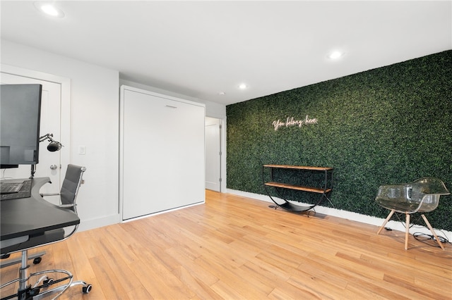 home office with wood-type flooring