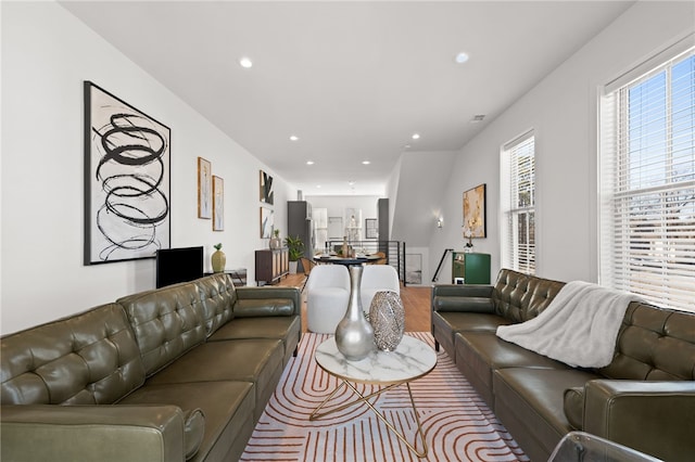 living room with wood finished floors and recessed lighting