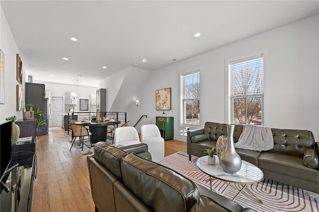 living area with light wood-style floors and recessed lighting