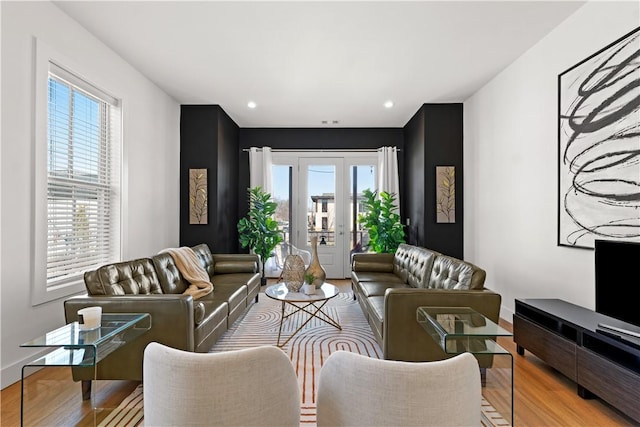 living room featuring baseboards, wood finished floors, and recessed lighting