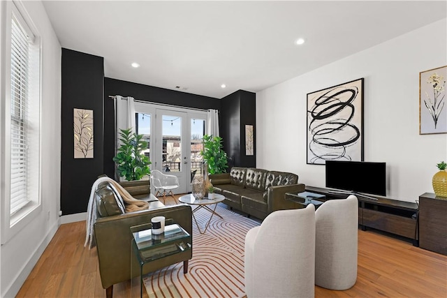 living area with baseboards, french doors, wood finished floors, and recessed lighting