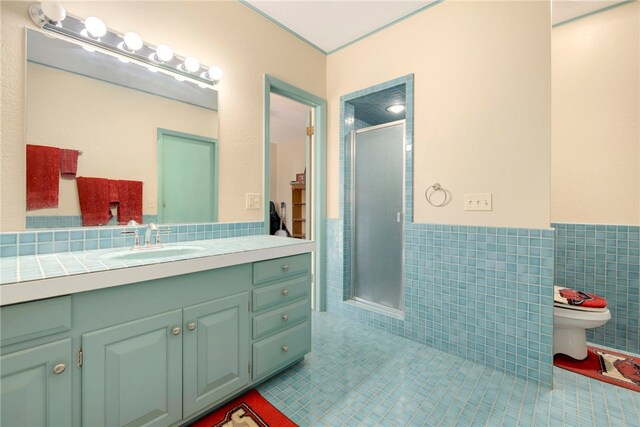 305 Irving St, Gravette, AR 72736 - bathroom featuring tile patterned floors, vanity, a shower with door, and tile walls