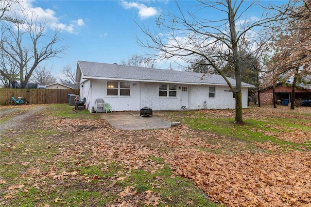 back of property with a patio and an outdoor fire pit