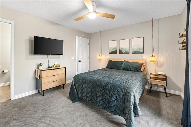 carpeted bedroom featuring a textured ceiling and ceiling fan