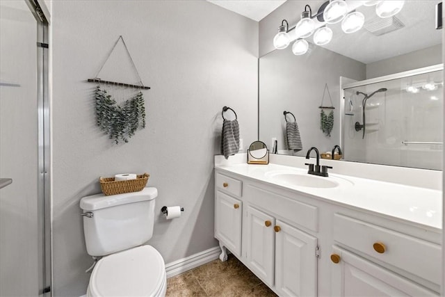 bathroom with tile patterned floors, vanity, toilet, and an enclosed shower