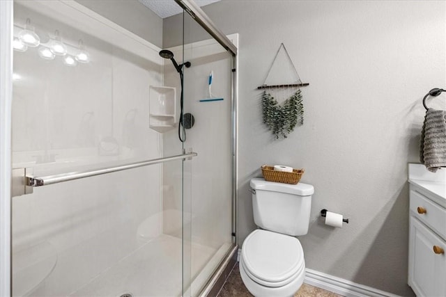 bathroom with walk in shower, tile patterned floors, vanity, and toilet