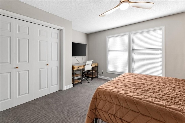 carpeted bedroom with a textured ceiling, a closet, and ceiling fan