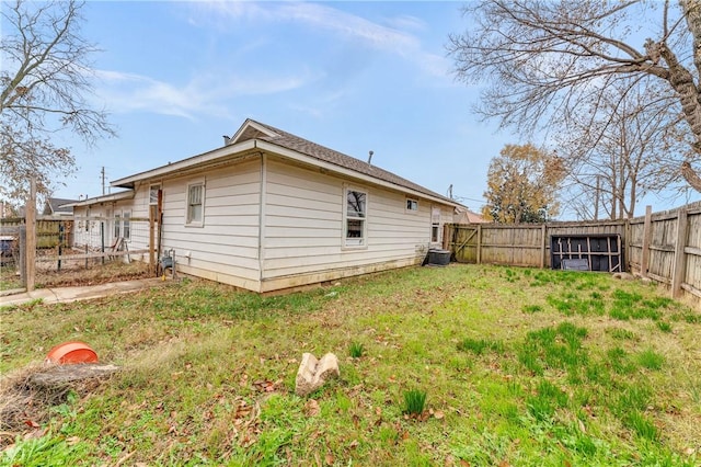 view of home's exterior with a yard and central AC