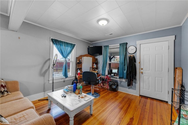 living room featuring hardwood / wood-style flooring and crown molding