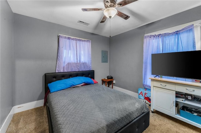 carpeted bedroom featuring electric panel and ceiling fan