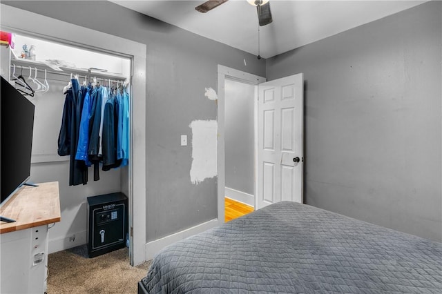 carpeted bedroom with a closet and ceiling fan