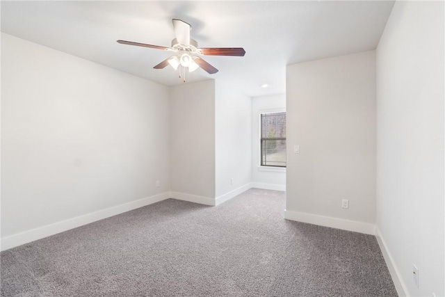 carpeted empty room featuring ceiling fan