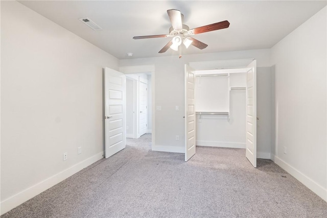 unfurnished bedroom with ceiling fan, light carpet, and a closet