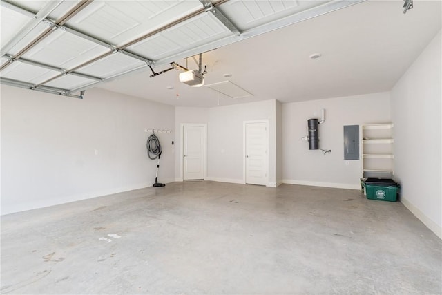 garage with a garage door opener and electric panel