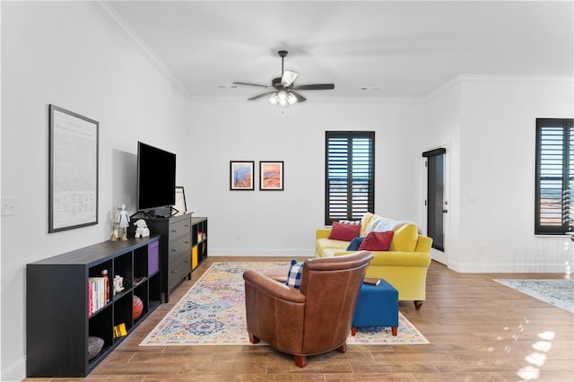 living room featuring crown molding, hardwood / wood-style floors, and a healthy amount of sunlight