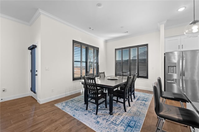 dining room featuring dark hardwood / wood-style floors and ornamental molding