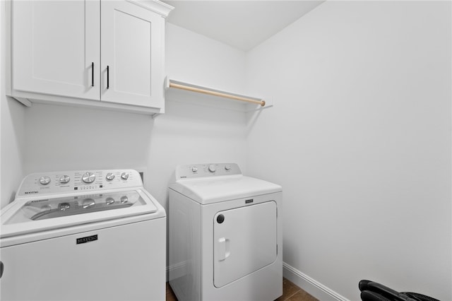 washroom featuring cabinets and washing machine and dryer