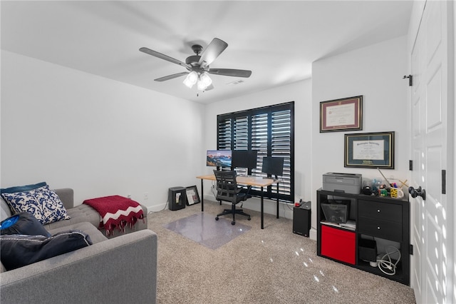 carpeted office space with ceiling fan