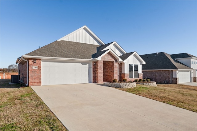 view of front of house featuring cooling unit, a garage, and a front lawn