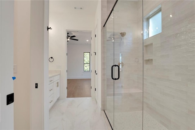 full bathroom featuring visible vents, marble finish floor, a shower stall, ceiling fan, and vanity