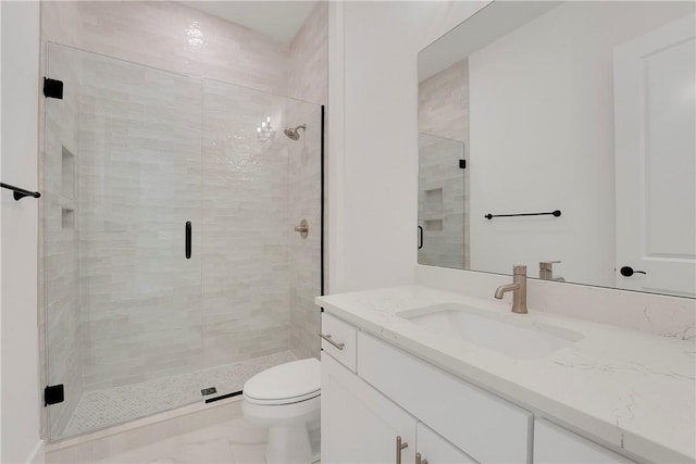 full bathroom with vanity, toilet, and a shower stall