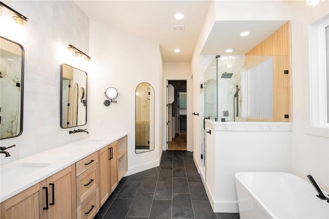 bathroom with tile patterned flooring, shower with separate bathtub, and vanity