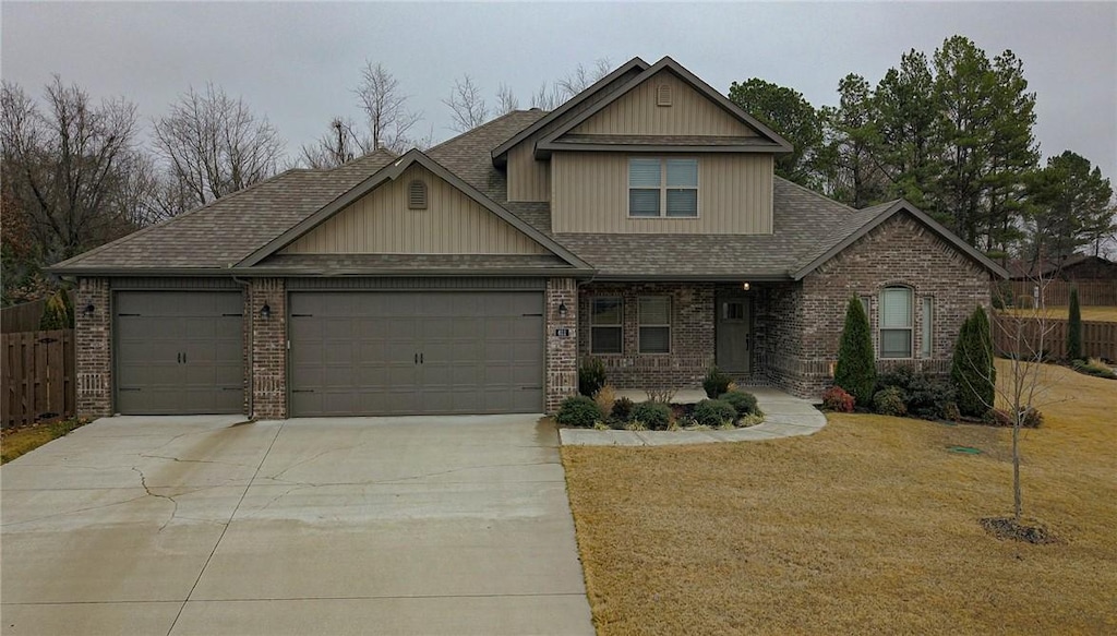 craftsman-style home featuring a front yard and a garage