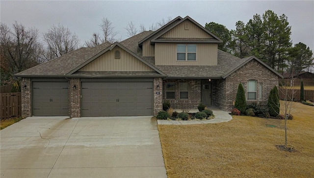 craftsman-style home featuring a front yard and a garage