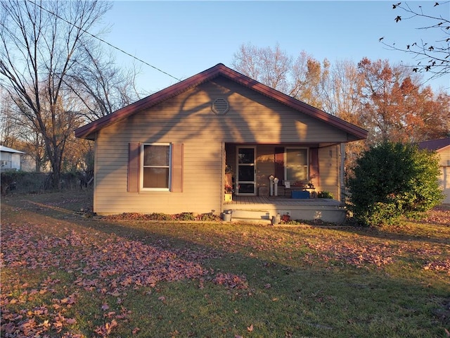 view of front of home with covered porch and a front yard