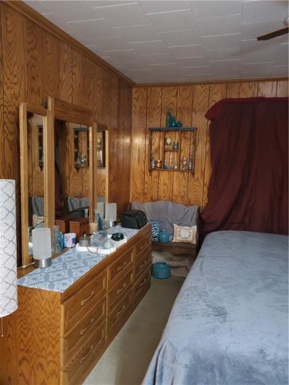 bedroom with wood walls and carpet floors