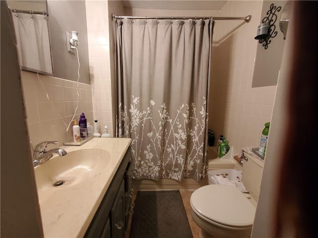 bathroom featuring vanity, tile patterned floors, a shower with curtain, toilet, and tile walls