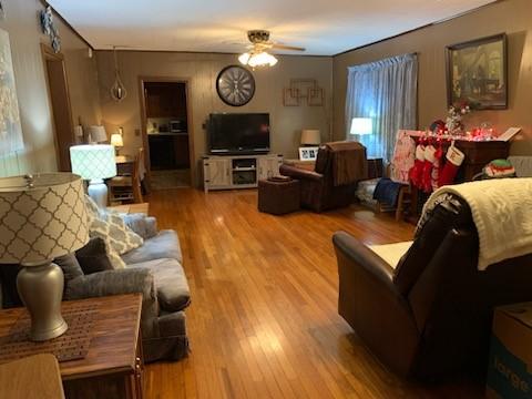 living room with hardwood / wood-style floors and ceiling fan