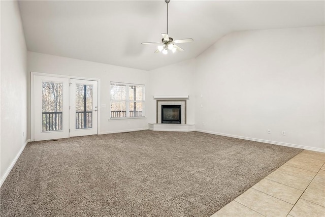 unfurnished living room with ceiling fan, light tile patterned flooring, and lofted ceiling