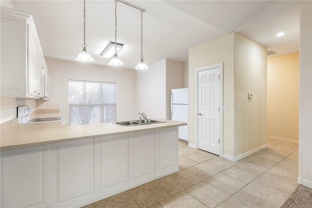 kitchen with white appliances, sink, hanging light fixtures, light tile patterned floors, and white cabinetry