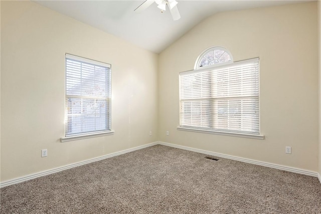 carpeted spare room featuring ceiling fan and lofted ceiling