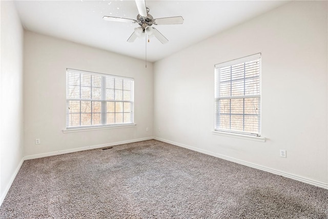 carpeted empty room featuring ceiling fan and a healthy amount of sunlight