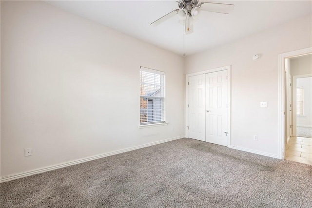 unfurnished bedroom featuring ceiling fan, a closet, and carpet floors