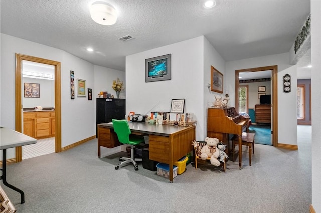 carpeted office with a textured ceiling