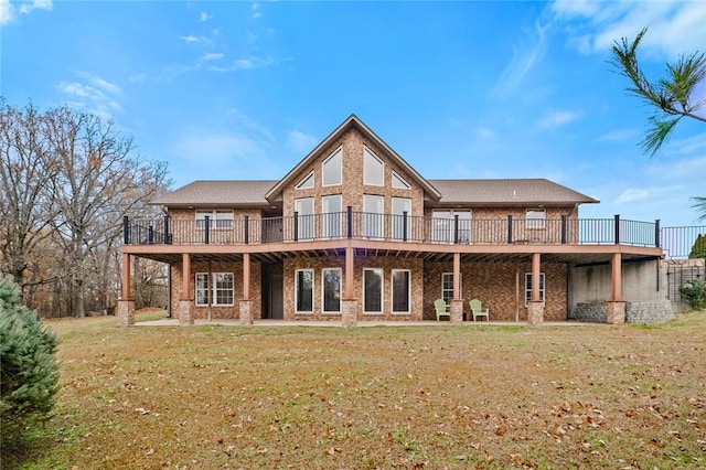 back of property with a yard and a wooden deck