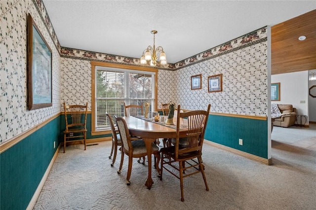 15262 Shipe Rd, Gravette, AR 72736 - dining room featuring wallpapered walls, a wainscoted wall, a chandelier, carpet floors, and baseboards