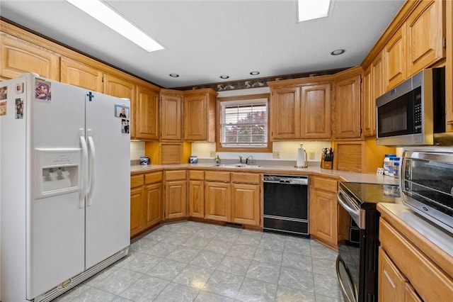 15262 Shipe Rd, Gravette, AR 72736 - kitchen with appliances with stainless steel finishes, light countertops, a sink, recessed lighting, and brown cabinetry