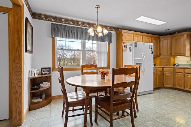 15262 Shipe Rd, Gravette, AR 72736 - dining space featuring a chandelier and baseboards