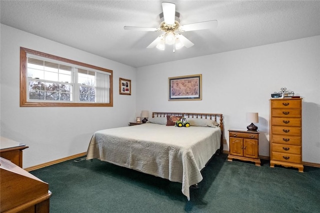 carpeted bedroom featuring ceiling fan and a textured ceiling