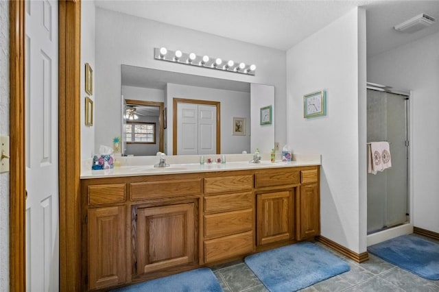 bathroom featuring tile patterned floors, vanity, and an enclosed shower