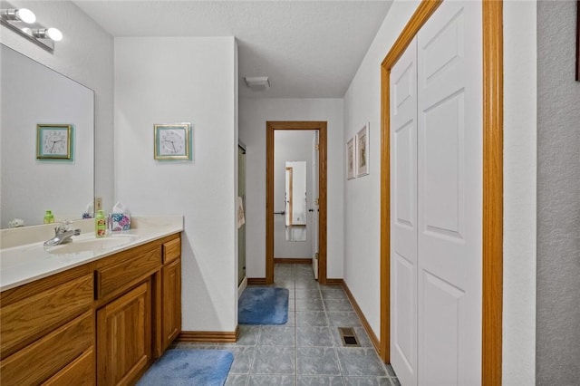 15262 Shipe Rd, Gravette, AR 72736 - full bathroom with vanity, a stall shower, a closet, tile patterned flooring, and baseboards