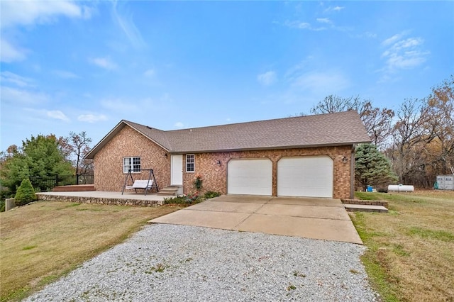 ranch-style house featuring a front lawn and a garage