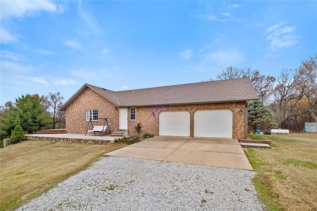 15262 Shipe Rd, Gravette, AR 72736 - ranch-style home featuring driveway, brick siding, an attached garage, and a front lawn
