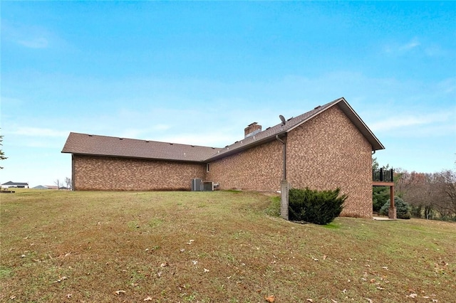 view of side of home with a yard