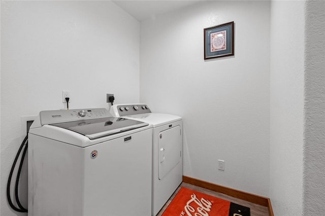 clothes washing area with washing machine and dryer