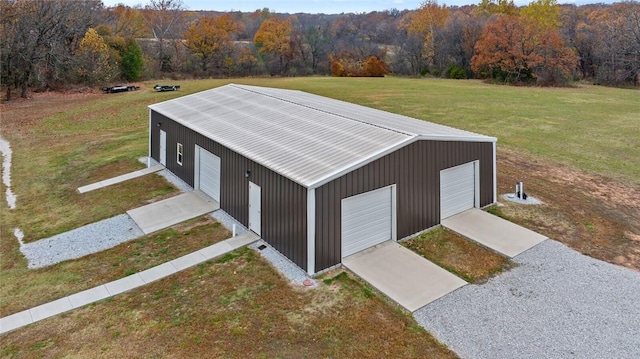 view of outdoor structure with a lawn and a garage